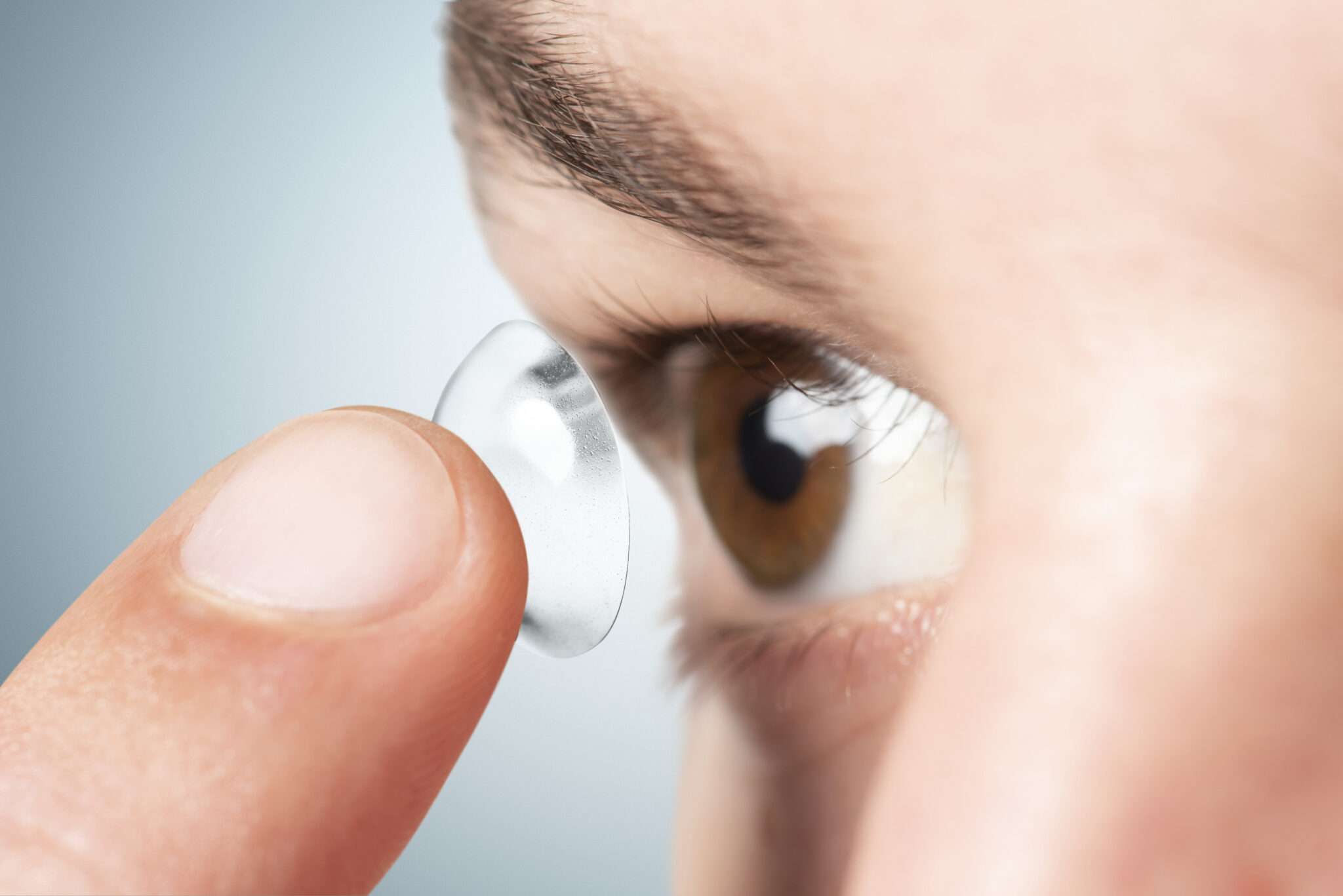 Man applying his contact lens